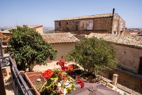 a view of a balcony with trees and red flowers at Villa Amoroso - Ospitalità Mediterranea in Agrigento