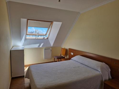 A bed or beds in a room at Apartamento Foz Playa
