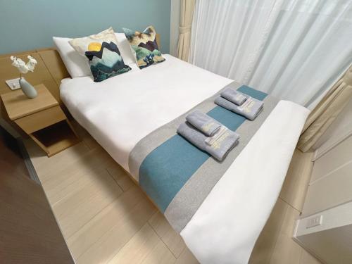 a bedroom with two beds with towels on them at nestay inn tokyo ueno in Tokyo