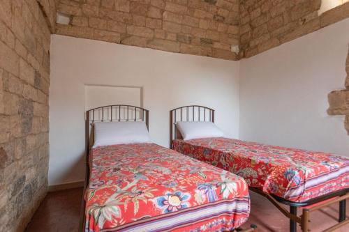 a room with two beds in a room at Trullo Franza - Salento Reservation in Torre Suda
