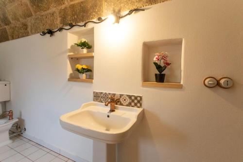 a bathroom with a sink and a toilet at Trullo Franza - Salento Reservation in Torre Suda