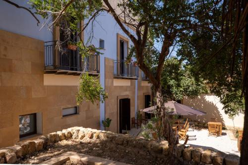 an external view of a building with a tree at Villa Amoroso - Ospitalità Mediterranea in Agrigento