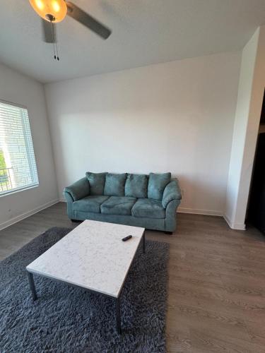 a living room with a couch and a coffee table at cozy apartment in Leander in Leander