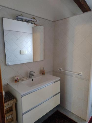 a bathroom with a sink and a mirror at L'Onda in Oristano