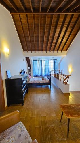 a large room with a bed and a staircase at Apartamento Terra e Mar II in Ponta Garça