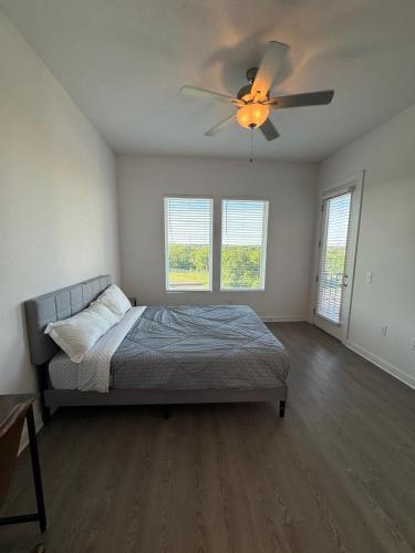 a bedroom with a bed and a ceiling fan at cozy apartment in Leander in Leander