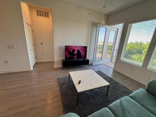 a living room with a couch and a table at cozy apartment in Leander in Leander