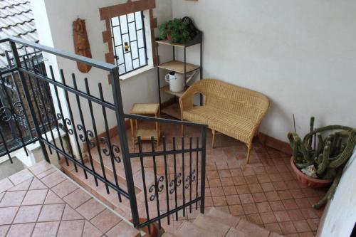 a room with a staircase with a chair and a plant at La Casa nel Sole Poggio Bustone in Poggio Bustone
