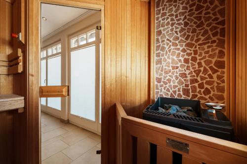 a room with a wooden wall with a window and a door at Hotel Meersinn - Binz in Binz