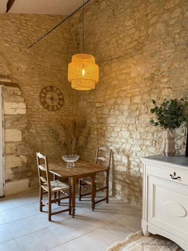 a dining room with a wooden table and chairs at Figtrees in Margueron