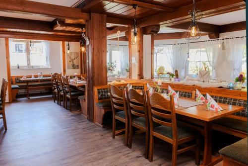 a dining room with wooden tables and chairs at Landgasthof zur Linde in Heimbuchenthal