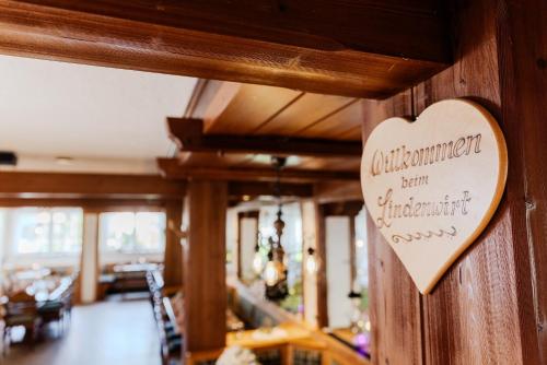 a heart shaped sign on a wall in a restaurant at Landgasthof zur Linde in Heimbuchenthal