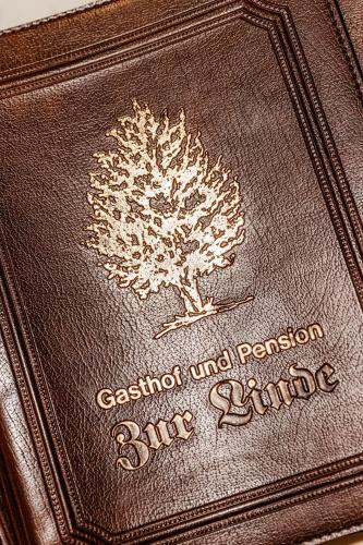 a brown passport with a picture of a tree on it at Landgasthof zur Linde in Heimbuchenthal