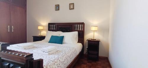 a bedroom with a bed with two towels on it at Casa da Praia - Family and Friends, Surf and Beach in Vila Praia de Âncora