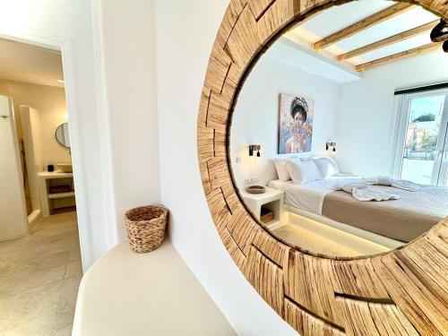 a bedroom with a mirror in front of a bed at La vie est belle luxury apartment BBQ jacuzzi&view in Pounda