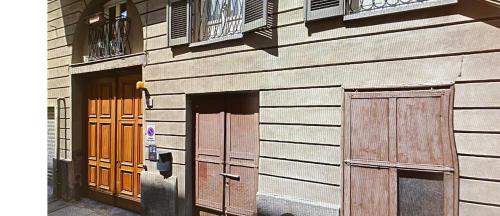 a building with wooden doors and windows on it at Home Sweet Home in Asti