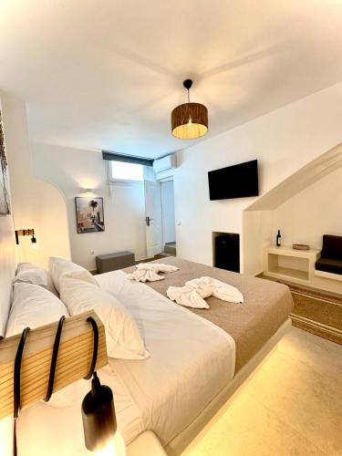 a bedroom with two beds and a flat screen tv at La vie est belle luxury apartment BBQ jacuzzi&view in Pounda