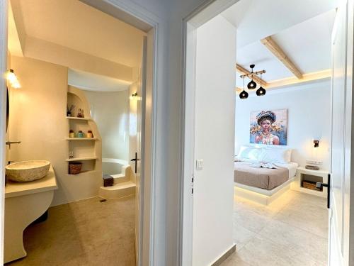 a bedroom with a bed and a bathroom at La vie est belle luxury apartment BBQ jacuzzi&view in Pounda