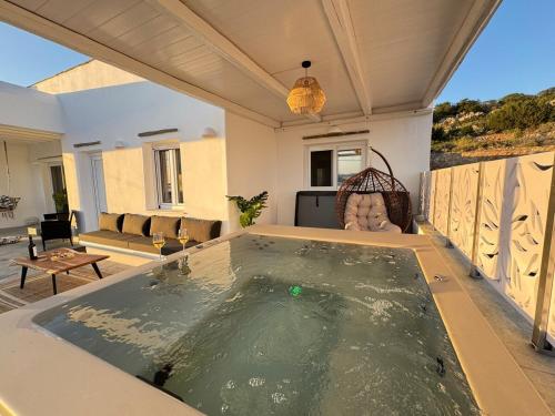 a large pool of water in the middle of a living room at La vie est belle luxury apartment BBQ jacuzzi&view in Pounda