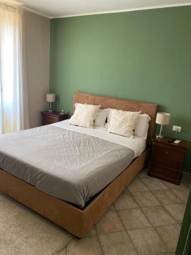 a bedroom with a large bed with two night stands at Kalote' On The Roof Apartments in Noto