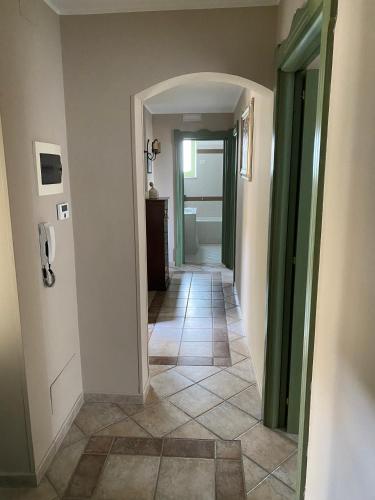 a hallway leading to a bathroom with a tile floor at Kalote' On The Roof Apartments in Noto