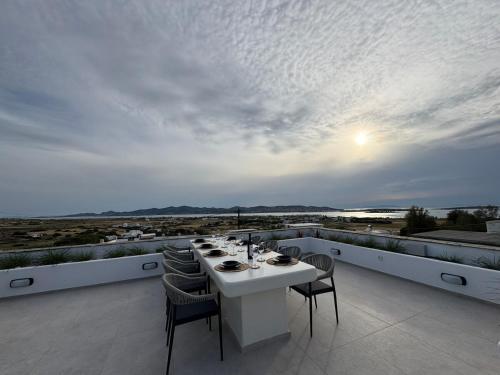 a white table and chairs on a balcony at La vie est belle luxury apartment BBQ jacuzzi&view in Pounda