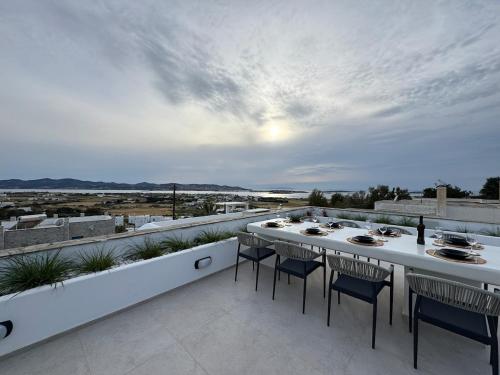 a table and chairs on a balcony with a view at La vie est belle luxury apartment BBQ jacuzzi&view in Pounda
