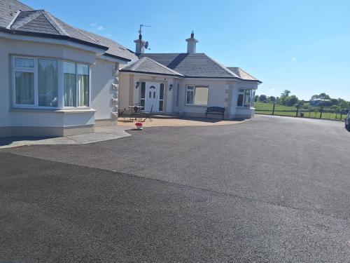 a house with a driveway in front of it at Ballnamona house in Cong