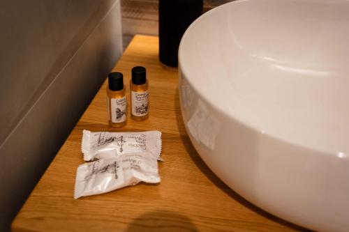 a bathroom with a toilet and two bottles on a table at Residenza Gurnea - Free Private Parking in Tropea