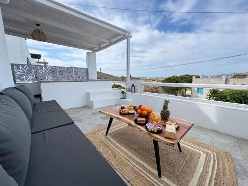 a table on a balcony with fruit on it at La vie est belle luxury apartment BBQ jacuzzi&view in Pounda