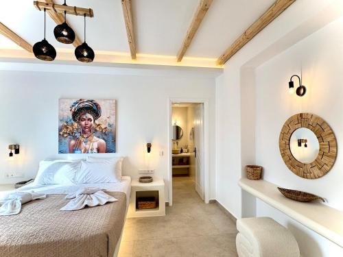 a bedroom with a bed with a painting on the wall at La vie est belle luxury apartment BBQ jacuzzi&view in Pounda