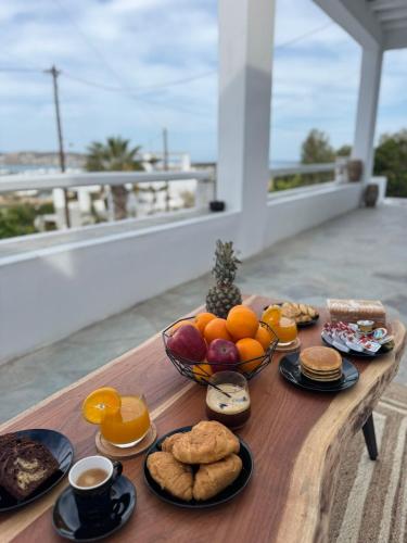 a table with a bowl of fruit and a bowl of cookies and oranges at La vie est belle luxury apartment BBQ jacuzzi&view in Pounda