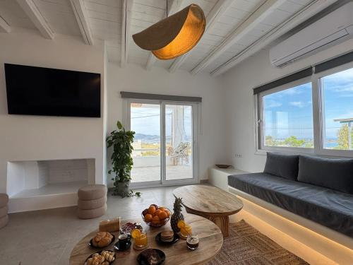 a living room with a couch and a table at La vie est belle luxury apartment BBQ jacuzzi&view in Pounda