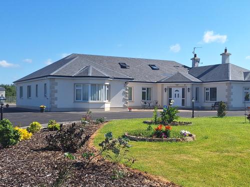 a house with a garden in front of it at Ballnamona house in Cong