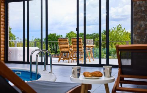a patio with a hot tub and a table and chairs at Holiday Home Zeleni Brijeg by Villas Guide in Petrinja