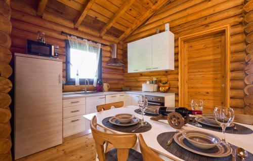 a kitchen with a dining table in a log cabin at Holiday Home Zeleni Brijeg by Villas Guide in Petrinja