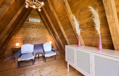 a room with a table and chairs in a attic at Holiday Home Zeleni Brijeg by Villas Guide in Petrinja