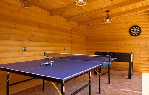 a ping pong table in a room with wooden walls at Holiday Home Zeleni Brijeg by Villas Guide in Petrinja