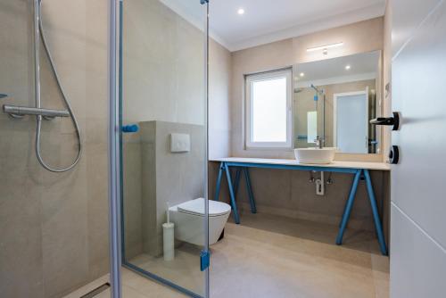 a bathroom with a sink and a shower at Pomalo apartments Vodice in Vodice