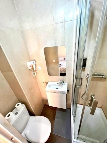 a bathroom with a toilet and a sink and a shower at MT Boutique Suites y Apartamentos - Adults Only - in Mataró