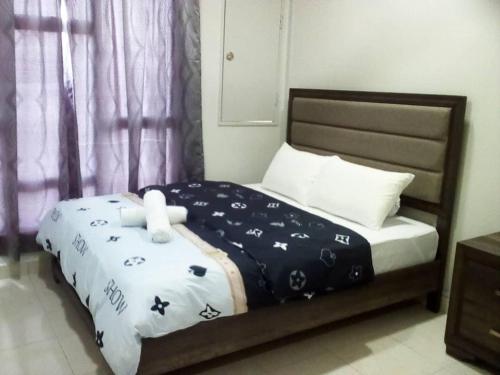 a bedroom with a bed with a teddy bear on it at Mstaycation in Melaka