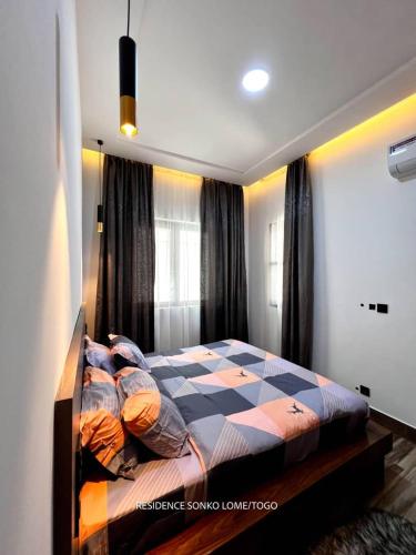 Una cama o camas en una habitación de Résidence Sonko