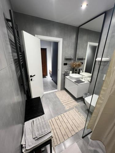 a bathroom with a toilet and a sink and a mirror at New loft style apartment in Uzhhorod