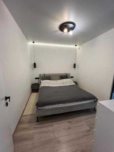 a bedroom with a bed in a white wall at New loft style apartment in Uzhhorod