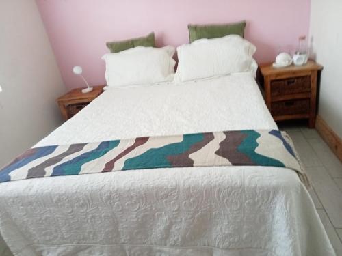 a bedroom with a bed with a camouflage blanket on it at Mandoo guesthouse in Vosburg