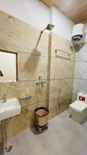 a bathroom with a sink and a shower and a toilet at Hotel Pushkar Town in Pushkar