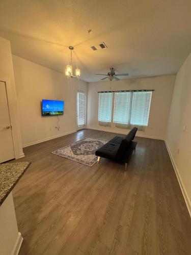 an empty living room with a couch and a tv at Leander Gem Near Austin in Leander