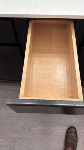 a person standing under a desk with a drawer at Leander Gem Near Austin in Leander