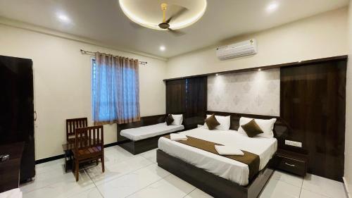 a hotel room with a bed and a chair at Hotel Pushkar Town in Pushkar