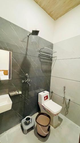 a bathroom with a toilet and a sink at Hotel Pushkar Town in Pushkar